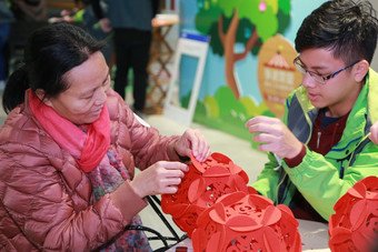 Participating student volunteer and beneficiary of CSPS make Lunar New Year decorations at one of the Chinese handcraft workshops to embrace the approach of the Year of the Dog.
