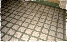 The floor is covered with white mosaic tiles of the 1940's decorated with green and dark red tessera.